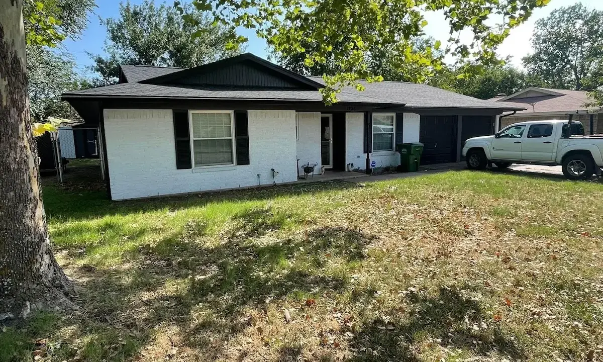 Professional roofing crew working on a residential roof in Paramount